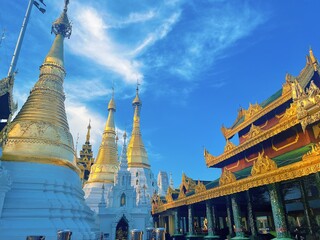 Naklejka premium Shwedagon Pagoda in Yangon Myanmar, Famous Golden Buddhist Temple Landmark with Blue Sky