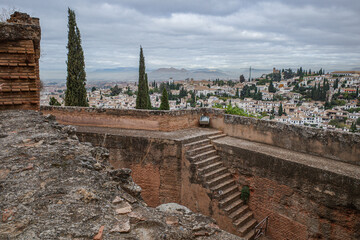 Fototapeta premium Granada, Spain - 21 Oct 2025: View of Granada cityscape from the Alcazaba, fortress towers and outer walls of Alhambra