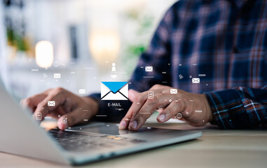 A businessman working on a laptop open email with sign reminder for unread emails for notification and taps on a new inbox email notification icon, newsletter. Technology digital online network