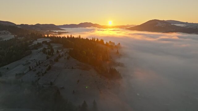 A Serene Sunrise Casts Its Glow Over Misty and Beautiful Hills