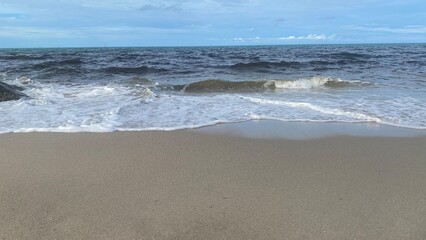 Sea Wave Crashing on Sandy Beach
