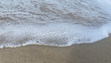 Sea Wave Crashing on Sandy Beach