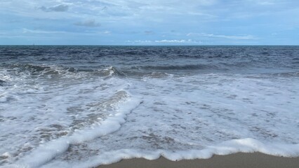 Sea Wave Crashing on Sandy Beach