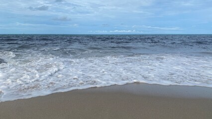 Sea Wave Crashing on Sandy Beach