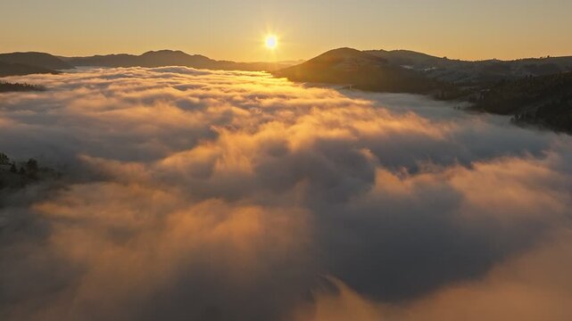 The Stunning and Beautiful Sunrise Peaks Over the Foggy Landscape