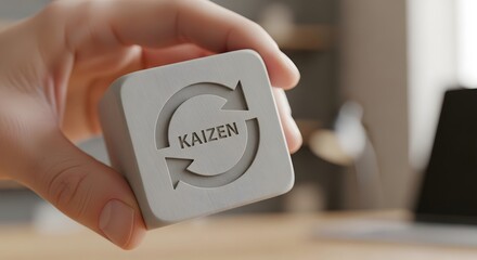 Kaizen Continuous Improvement Concept on Grey Cube with Circular Arrows