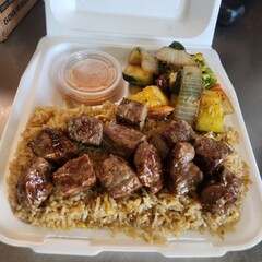 Assorted Grilled Meats, Shrimp, Vegetables, and Rice in Takeout Container with Sweet Sauce