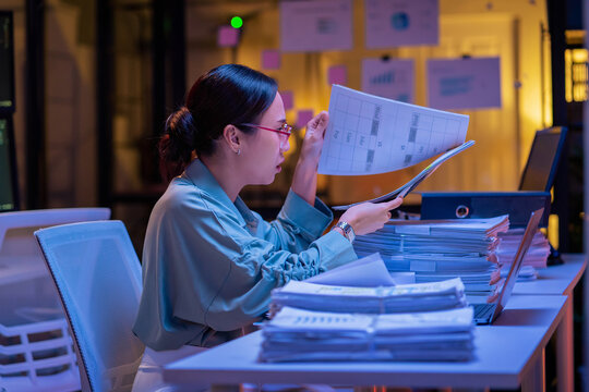 Asian female smart programmer works late night office coding deep learning AI models, training neural networks with intense concentration and focus, dedicating overtime hours alone to machine learning