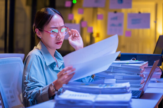 Asian female smart programmer works late night office coding deep learning AI models, training neural networks with intense concentration and focus, dedicating overtime hours alone to machine learning