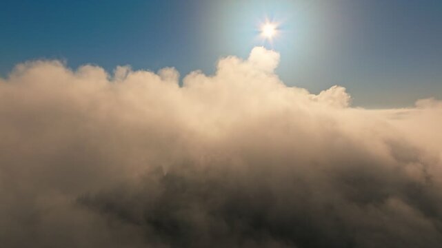 Majestic Sunlight Radiantly Shining Through Soft, Fluffy Clouds