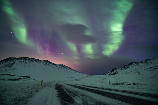 Aurora Borealis Over Snowy Road