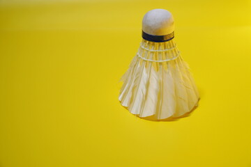 a shuttlecock isolated on a yellow background