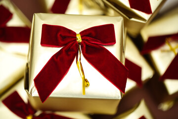 golden gift boxes with red bows arranged