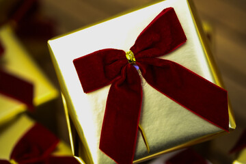 golden gift boxes with red bows arranged