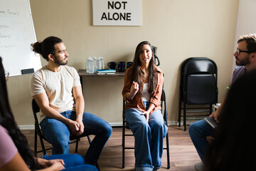 Crying woman sharing her story in group therapy session