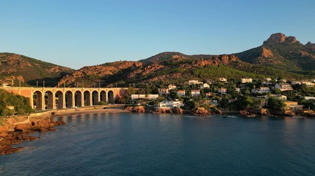 Aerial panoramic view of the Antheor Viaduct in the Esterel Mountains near Saint Raphael, French Riviera, overlooking the Mediterranean Sea and luxury villas along the Cote dAzur coastline at sunrise