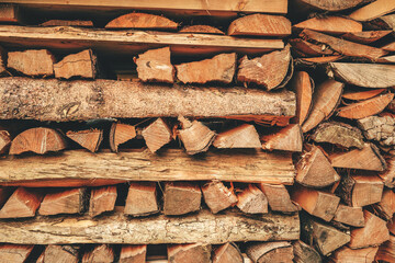 Firewood arranged in stacks on a farm as background as natural pattern