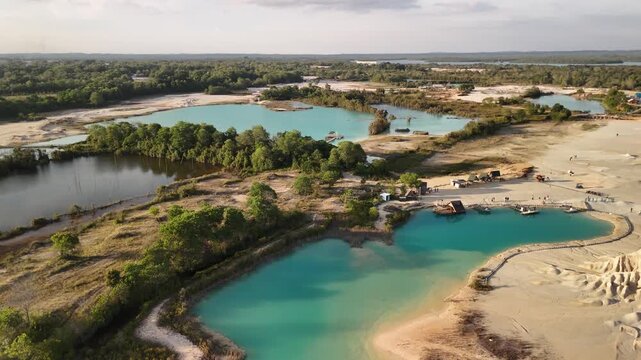 bintan islands blue lagoon also known as danau biru features striking turquoise waters surrounded by white sand hills creating a stunning contrast and serene tropical atmosphere