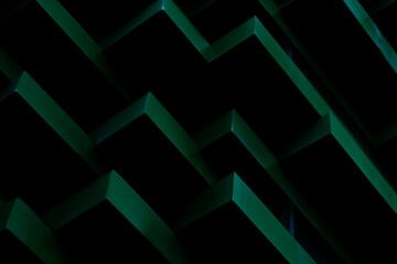 Close-up shot of a dark green geometric pattern with sharp edges and shadows.