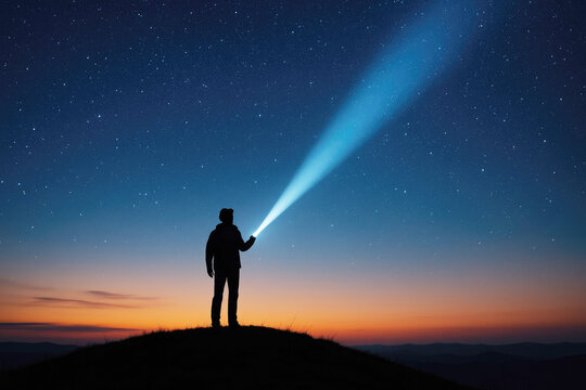 Silhouette of a person holding a flashlight on a hilltop at night with a starry sky and colorful horizon