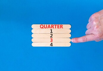 3rd third quarter 3 symbol. Concept word Quarter 3 on beautiful wooden sticks. Beautiful blue...