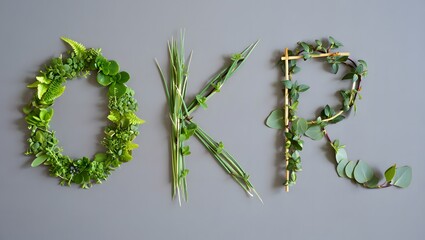 Obraz premium OKR letters formed from fresh green leaves and twigs