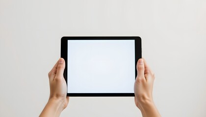Hands Holding a Tablet with a Blank White Screen Against a Minimalist Background