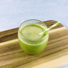 Single glass of smoothie made of green vegetables and fruits. 
