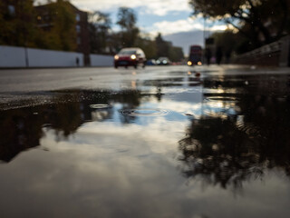 Puddle with reflections on a rainy street