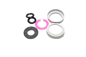 Set of gaskets for repairing a faucet valve body on a PNG background.