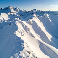 Aerial drone shot of snow-covered mountain patterns forming fractal geometry