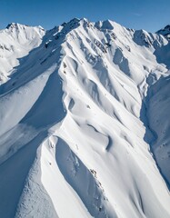 Aerial drone shot of snow-covered mountain patterns forming fractal geometry