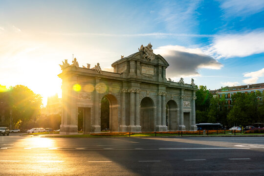 Puerta de Alcal&aacute; is bathed in golden sunset light in Madrid, Spain. The soft backlighting, lens flare, long shadows give the neoclassical monument a warm romantic atmosphere Plaza de la Independencia