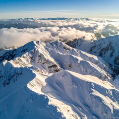 Aerial drone shot of snow-covered mountain patterns forming fractal geometry