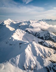 Aerial drone shot of snow-covered mountain patterns forming fractal geometry