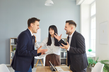 In an office, coworkers face a heated conflict and argument, rising with tension and stress, while...