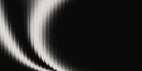 Abstract monochrome light beam with a smooth diagonal glow crossing a dark textured background....