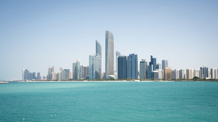 Coastal cityscape with high rise buildings and azure waters in foreground, United Arab Emirates