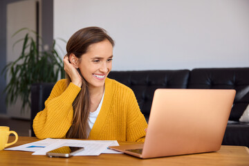 Young woman working with laptop at home