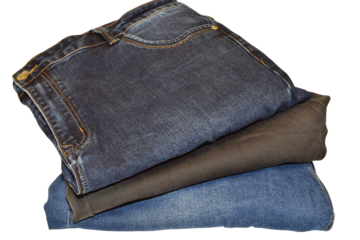 Blue jeans for men lie in a stack on a PNG background.