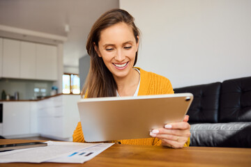 Young woman at home using digital tablet