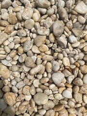 Smooth gray pebble stone beach texture background
