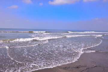 The scenic view from Laboni Point, a popular tourist spot on Cox's Bazar beach. Calm waves of the Bay of Bengal meet the sand under a beautiful blue sky. A perfect Bangladesh travel image.