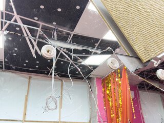 Abandoned office room destroyed by war actions and shooting. Window glass cracked by a bullet shot. Consequences of violence and aggression during war in Ukraine. View of a street from the inside.