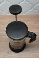 French press coffee maker on a wooden table