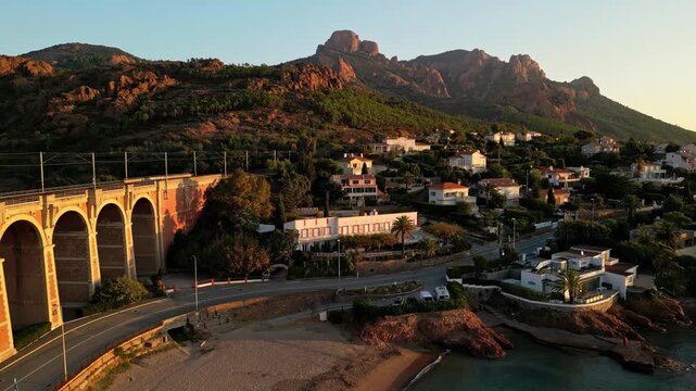 Aerial panoramic view of the Antheor Viaduct in the Esterel Mountains near Saint Raphael, French Riviera, overlooking the Mediterranean Sea and luxury villas along the Cote dAzur coastline at sunrise