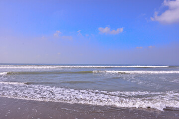 The scenic view from Laboni Point, a popular tourist spot on Cox's Bazar beach. Calm waves of the Bay of Bengal meet the sand under a beautiful blue sky. A perfect Bangladesh travel image.