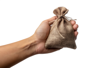 Human hand holding small burlap sack tied with twine isolated on a transparent background