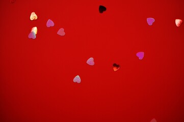 hearts confetti on red background