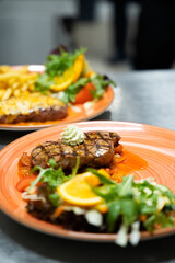 Grilled Steak with Salad and Orange Garnish